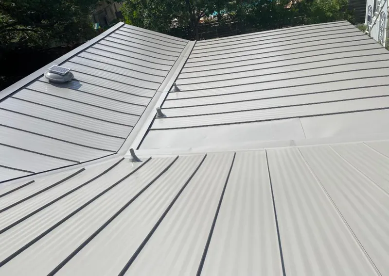 Solar attic fan installed on a metal roof for Roof Ventilation in Pearl