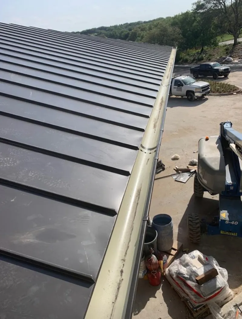 Standing seam panel and gutter detail on a metal roofing jobsite in Pearl